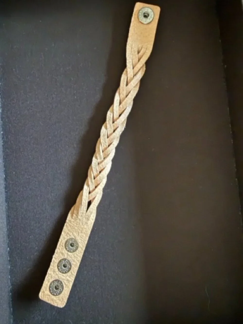 Mystery braid bracelet featuring an adjustable three-snap closure